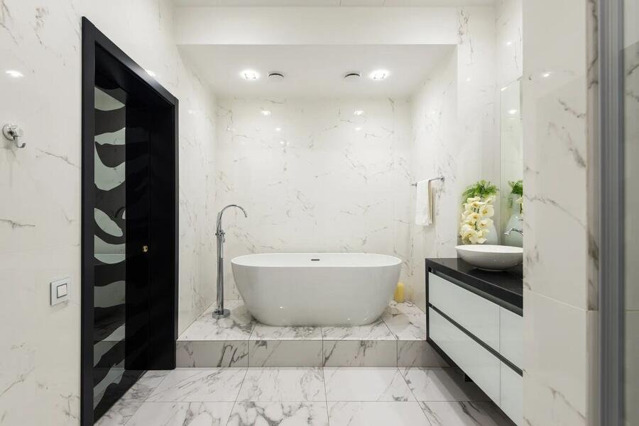 Freestanding tub and double vanity in a white bathroom