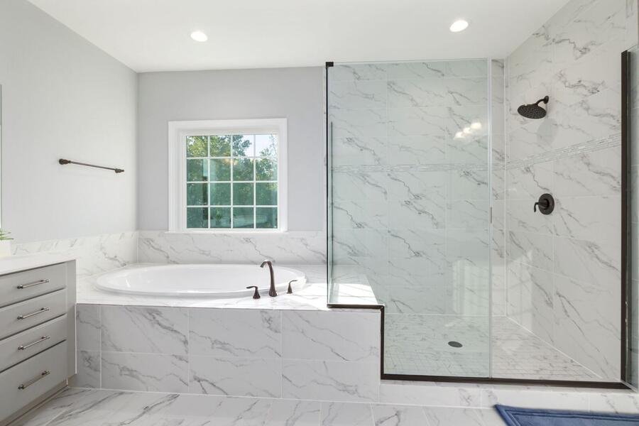 Marble bathroom with soaking tub and walk-in glass shower