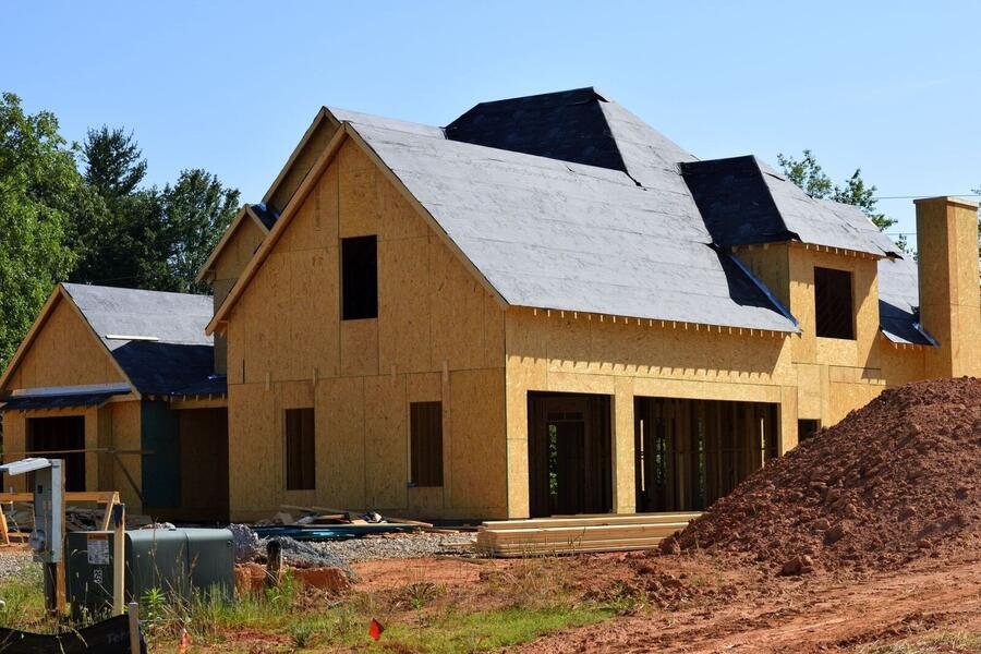 Custom home under construction with clean sheathing and roofline