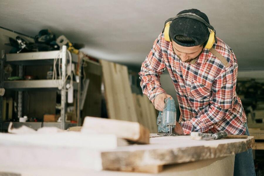 Master carpenter crafting custom millwork in a workshop
