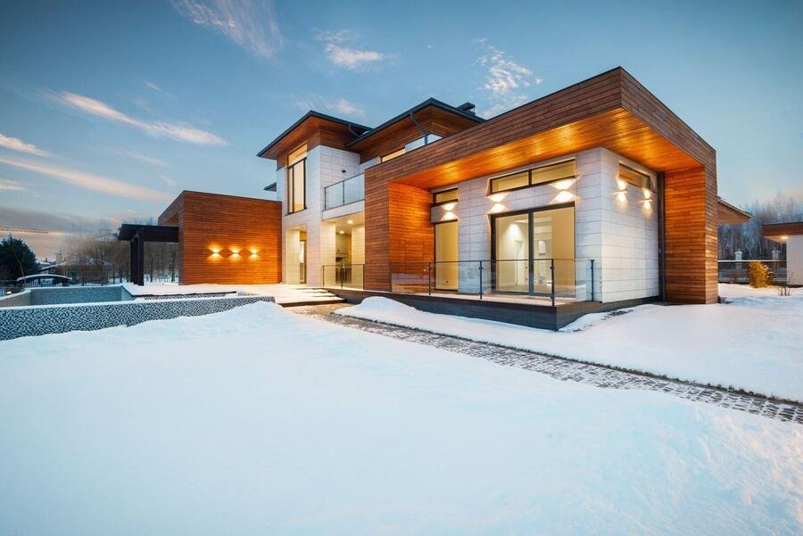 Contemporary custom home glowing at dusk