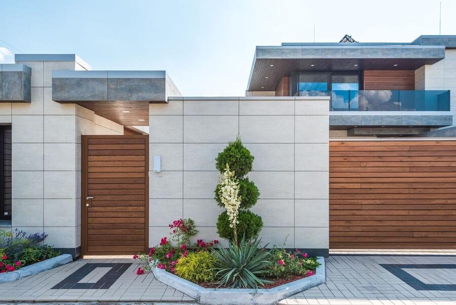 Custom home with stone driveway and sculptural garage