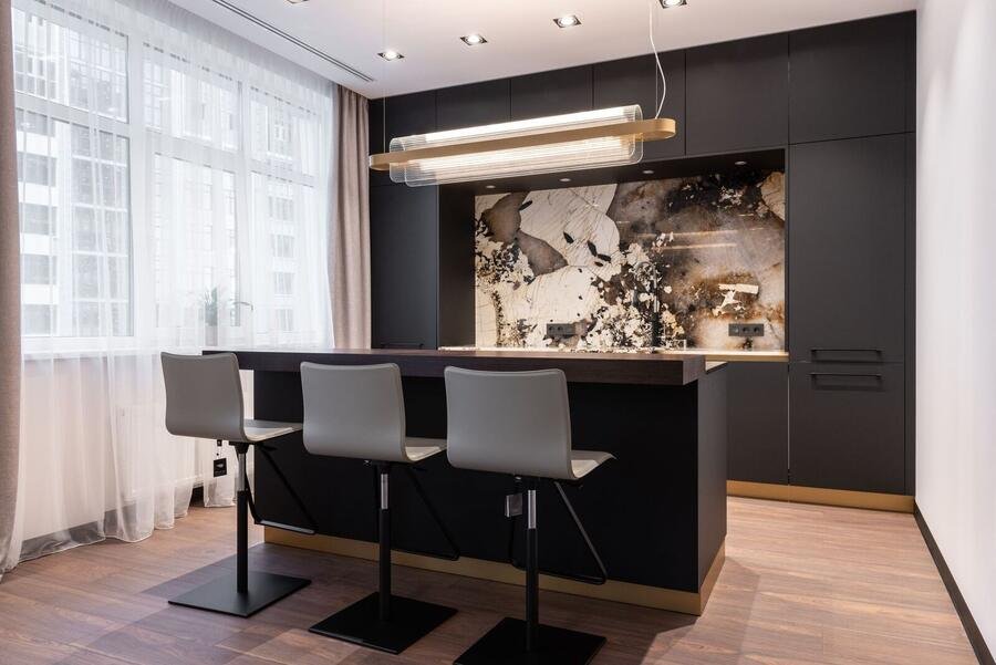 Dark moody luxury kitchen with brass details