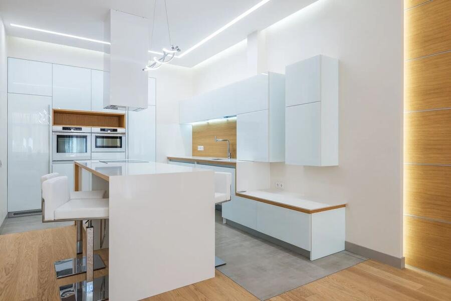 Warm wood and stone kitchen with integrated appliances